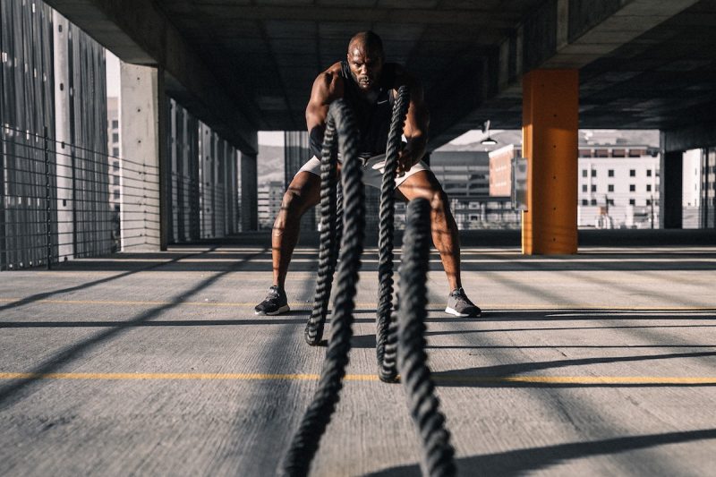 Man doing battle ropes workout.