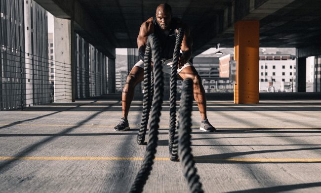 Man doing battle ropes workout.