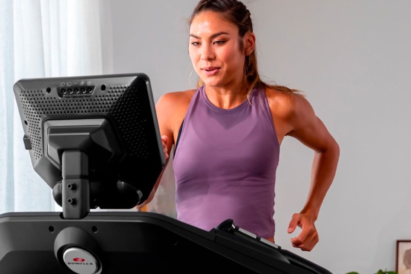 A woman runs on a Bowflex Treadmill 10.