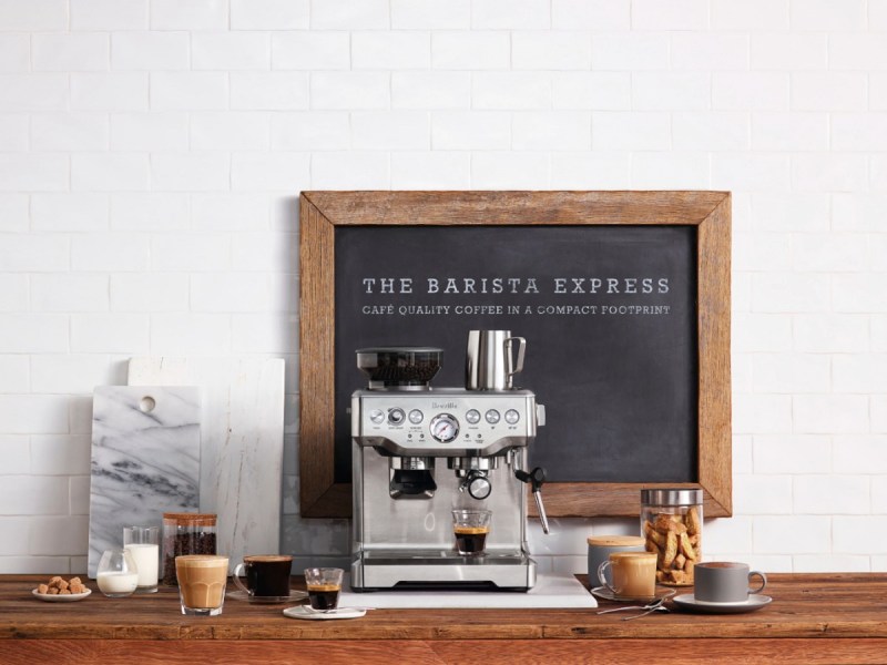 Breville's The Barista Express with beverages on a table.