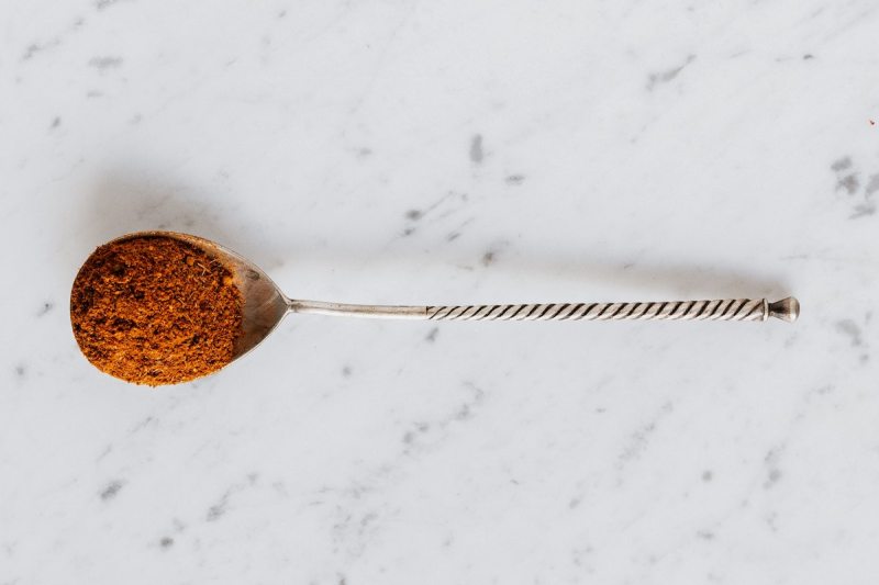 Ground cinnamon spice in a spoon
