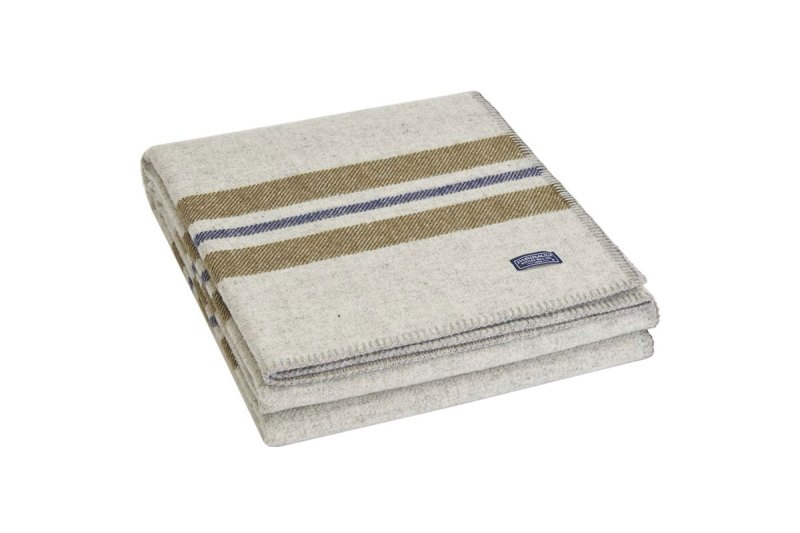 A neatly folded Faribault woolen blanket on plain background