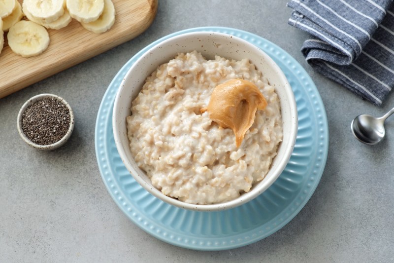 A bowl of oatmeal topped with banana slices.