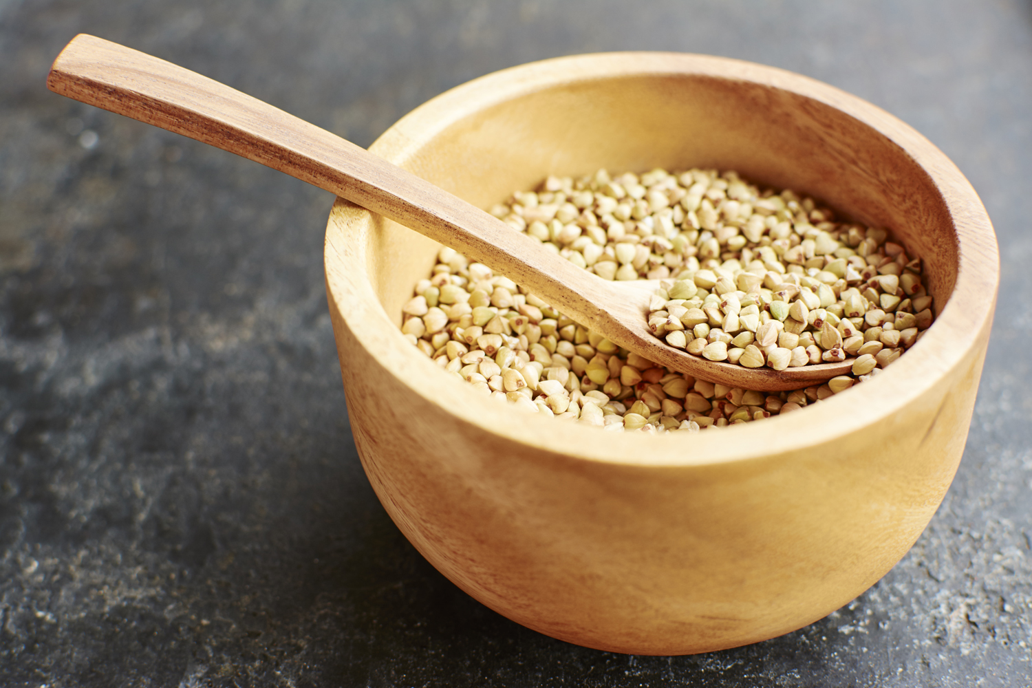 A wooden spoon in a bowl of hemp seeds