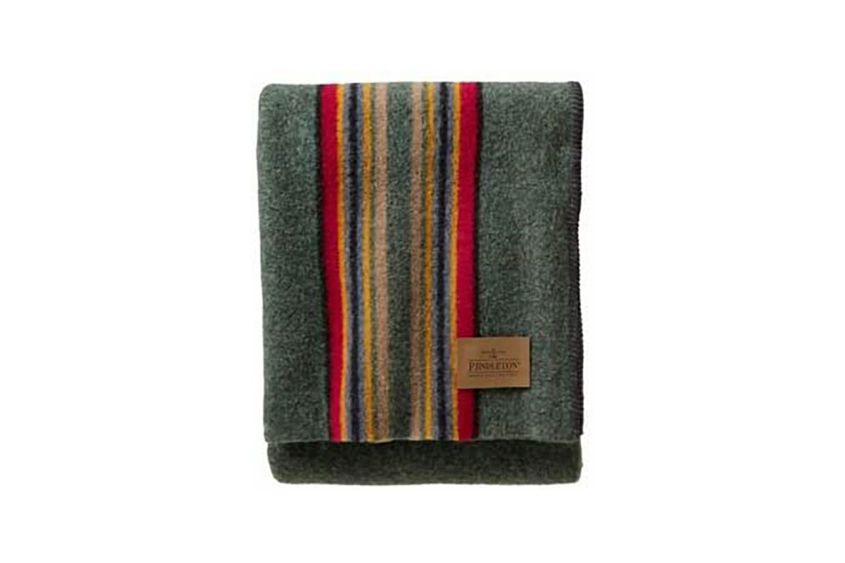 A striped green woolen blanket from Pendleton on plain background
