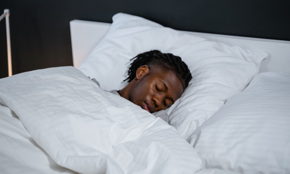 A man lies asleep in bed