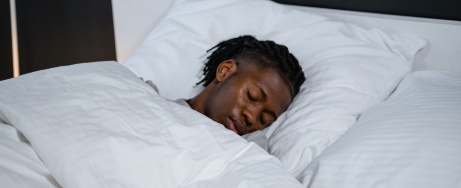 A man lies asleep in bed