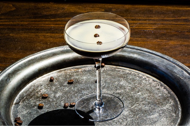 Skrewball peanut butter espresso martini sitting on a silver serving tray.