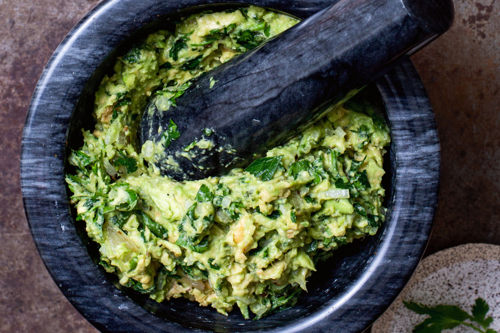 Smoky guacamole in a mortar and pestle.