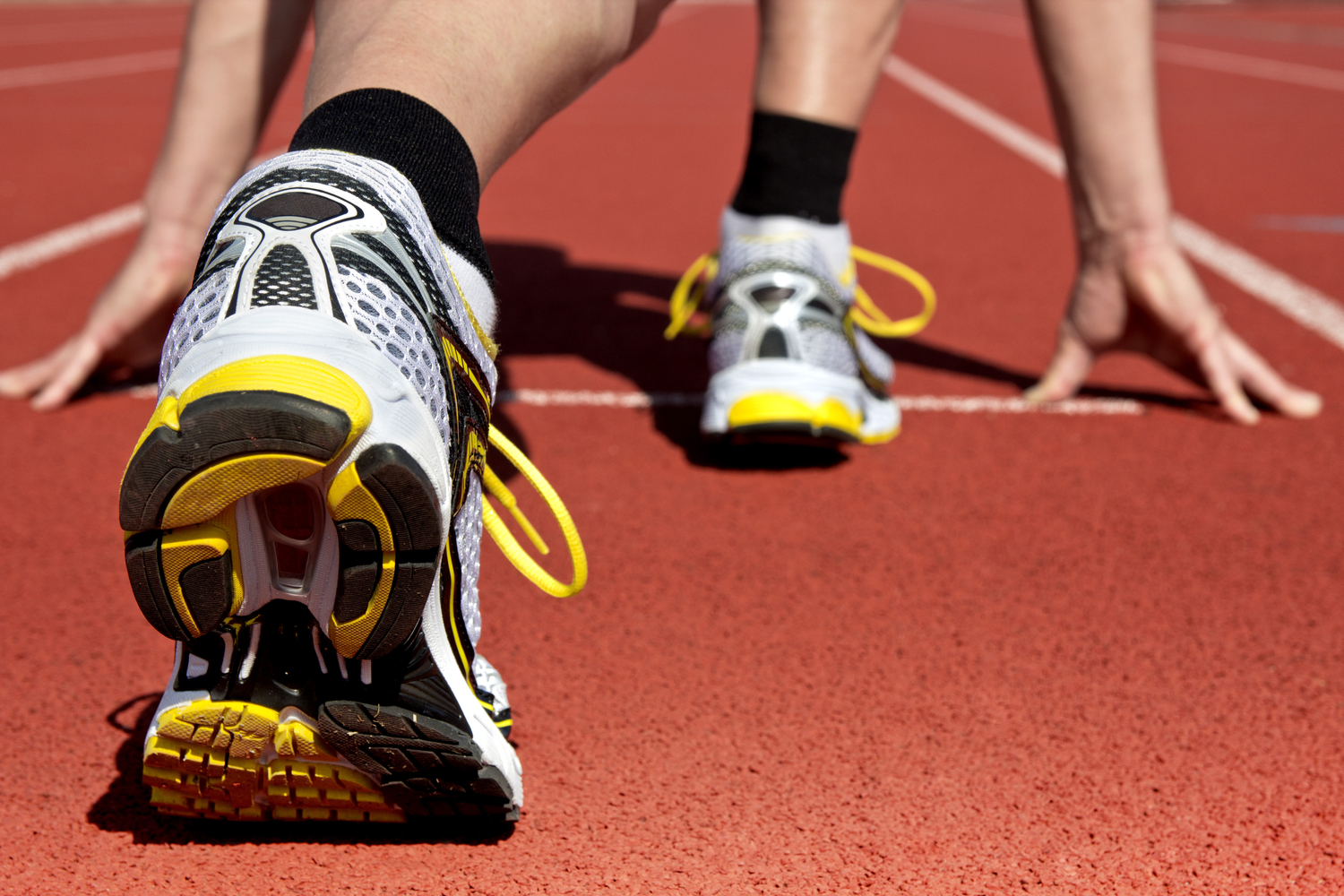 black tennis shoes on running track