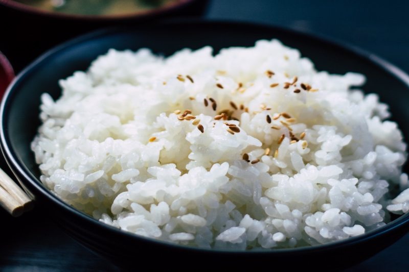 Bowl of white rice with sesame seeds.