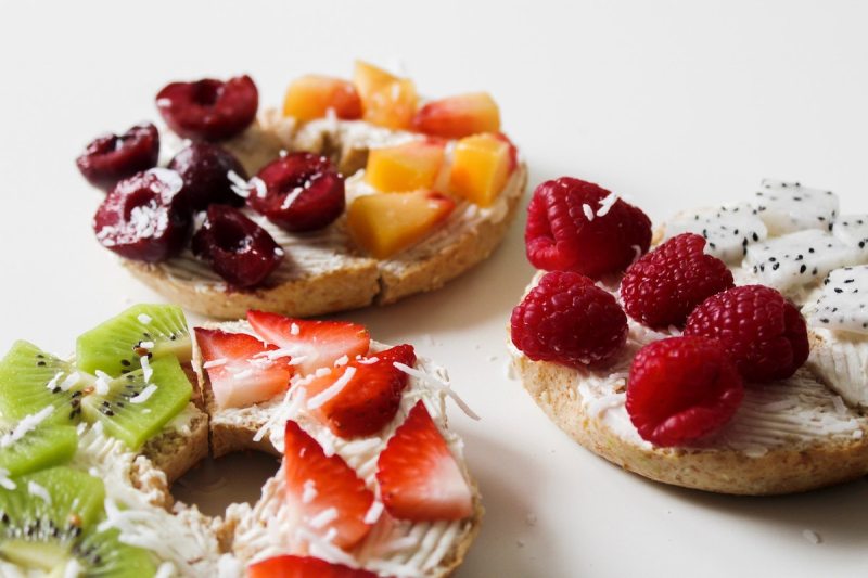 Fancy bagels with fruit toppings.