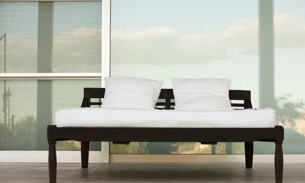 Bed on outdoor patio at resort.