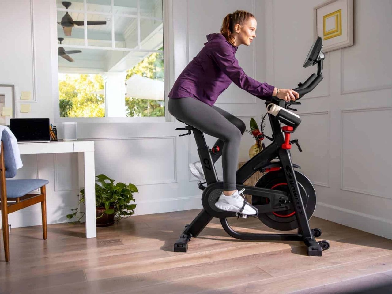 Woman using Bowflex C7 exercise bike.