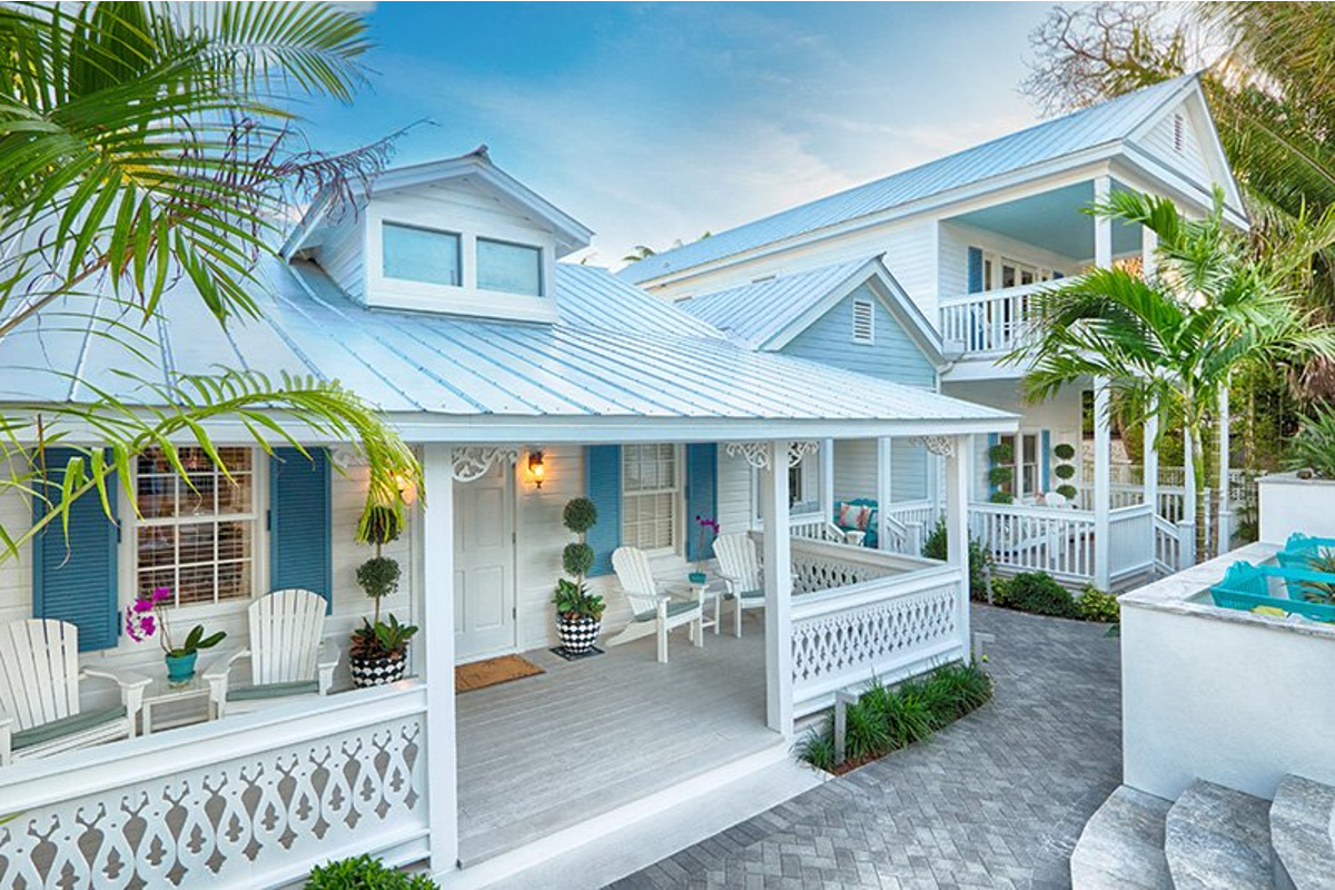 Exterior of blue and white buildings of Gardens Hotel.