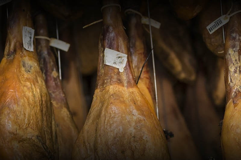 Fermin Acorn-Fed Iberico Shoulder Hams, which are hanging