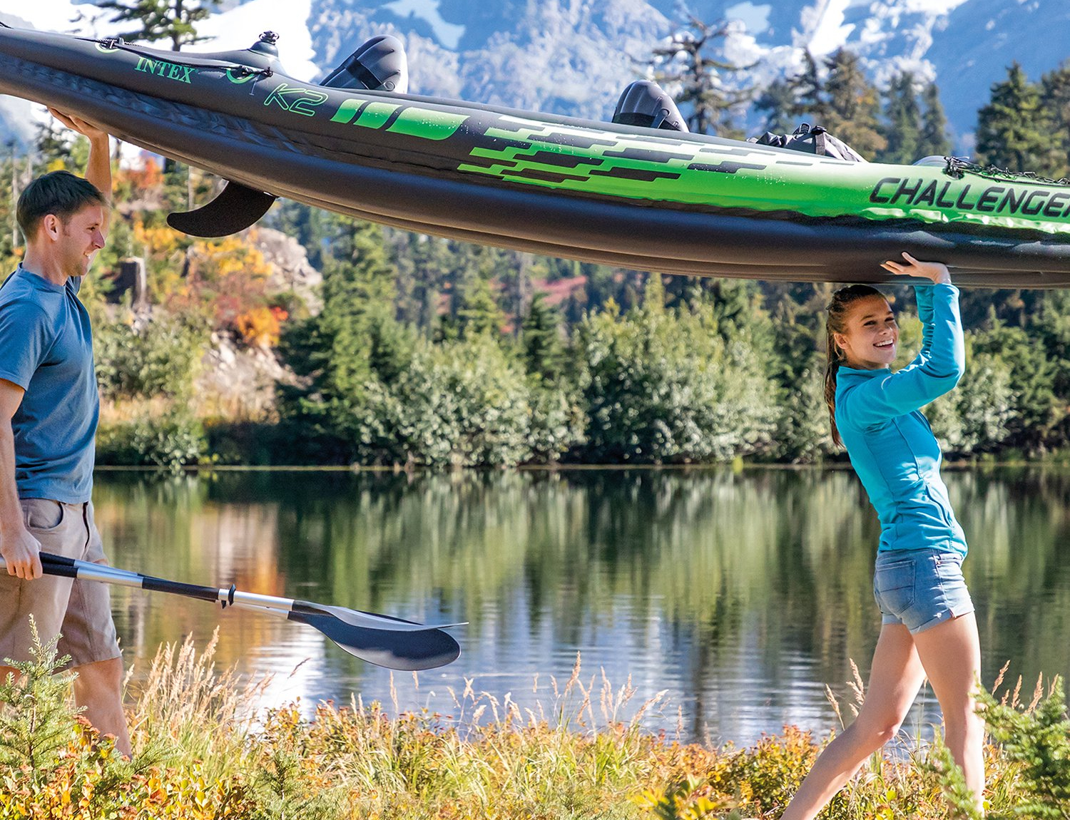 Man and woman portage an Intex Challenger K2 Inflatable Kayak.