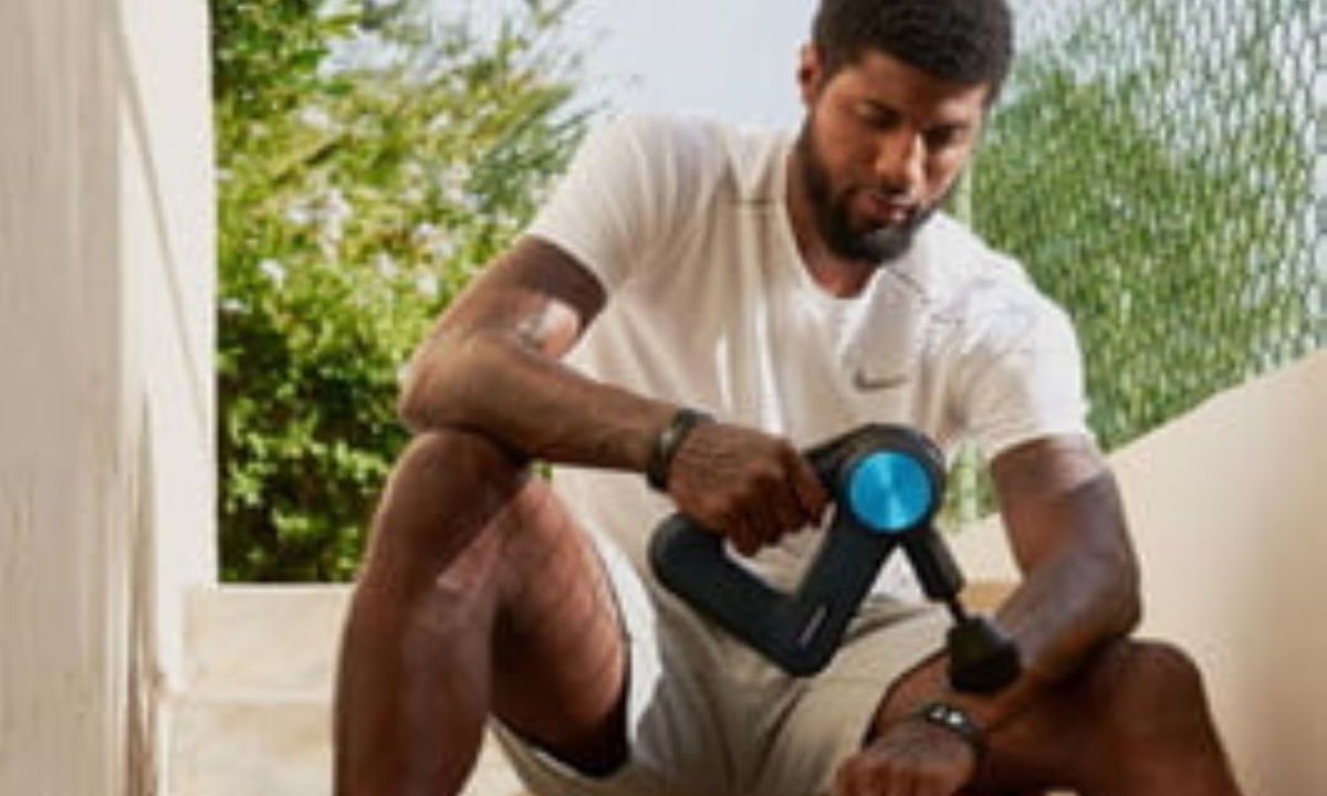 Man using a massage gun.