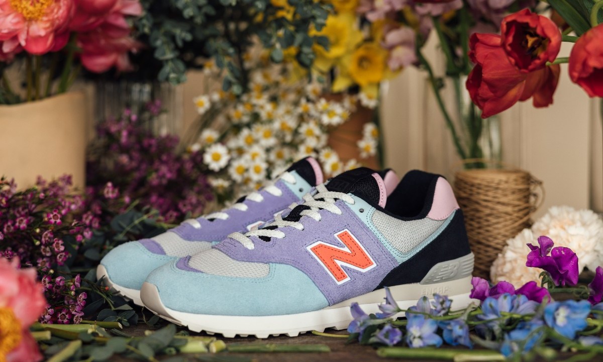 The New Balance 574 LDG Ma Divina surrounded by floral boquets.