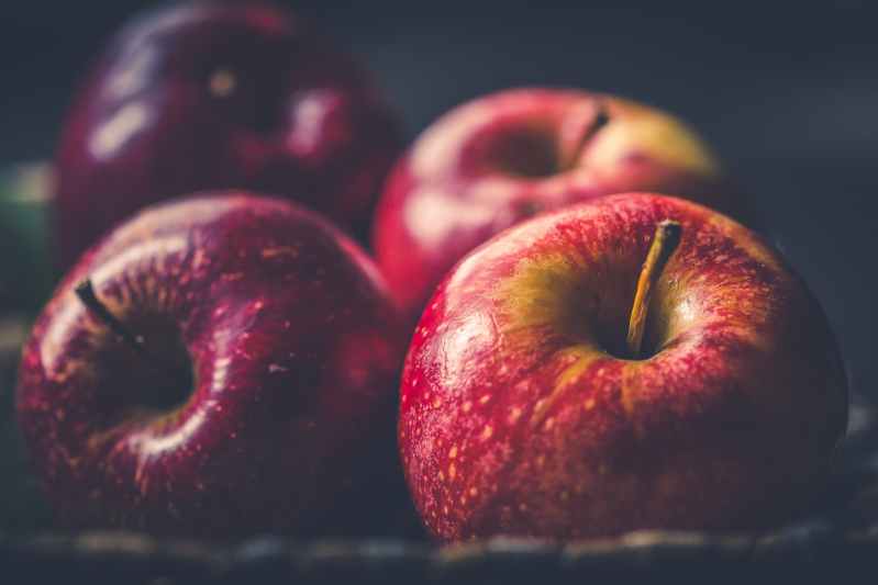 Red apples laying on surface