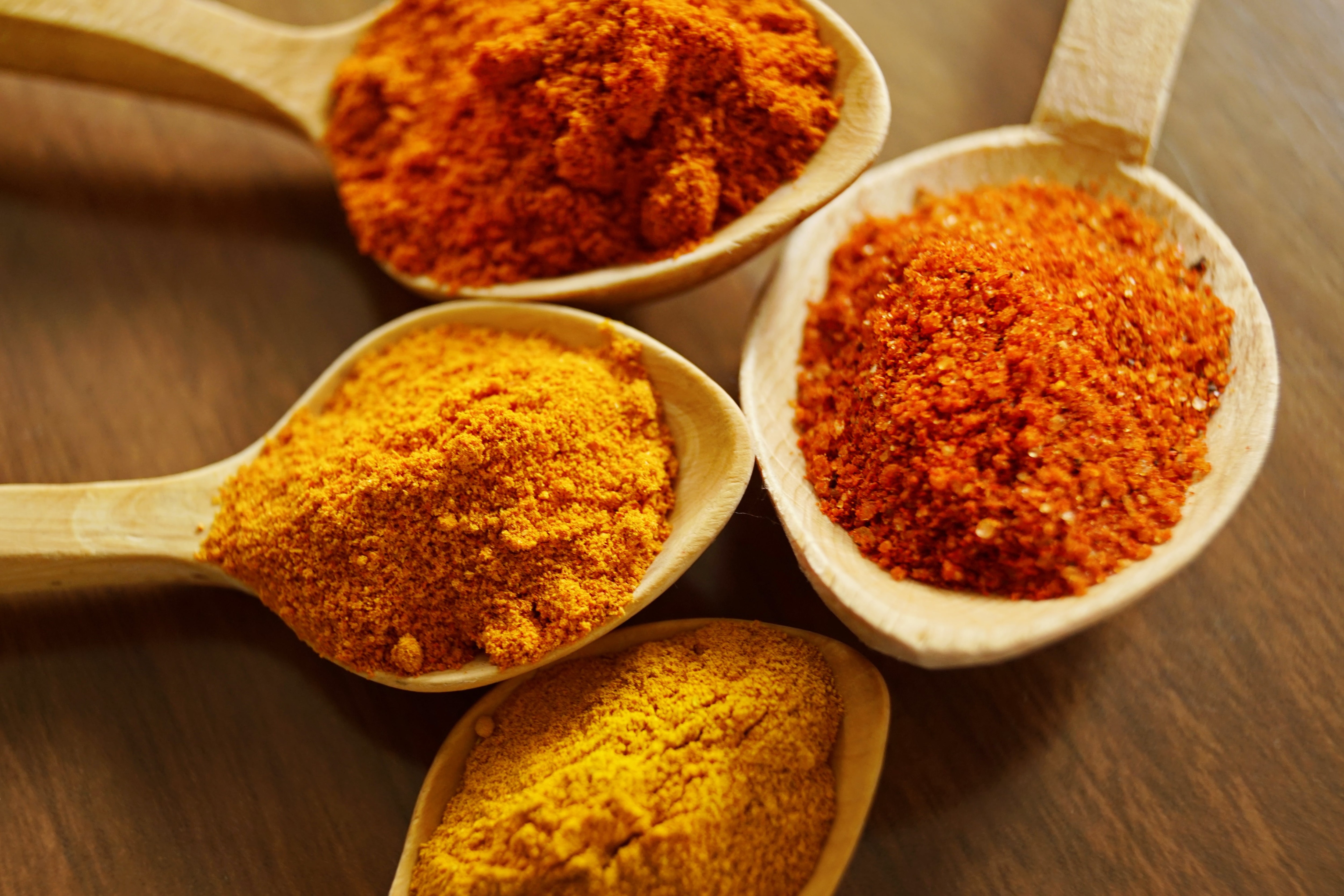 Four spoons with ground spices