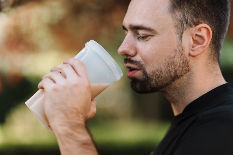 Man drinking a protein shake before exercising.