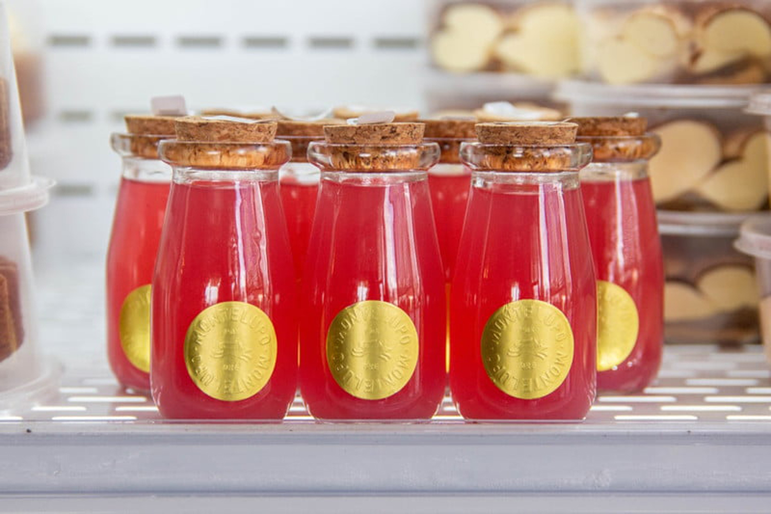 Several bottles of Rhubarb-Arita displayed on a tray.