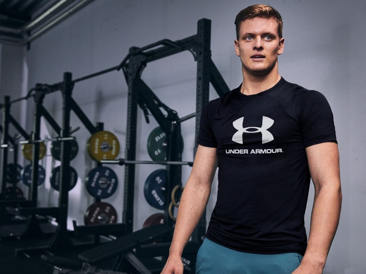 Mick Shumacher wearing Under Armour shirt in gym.