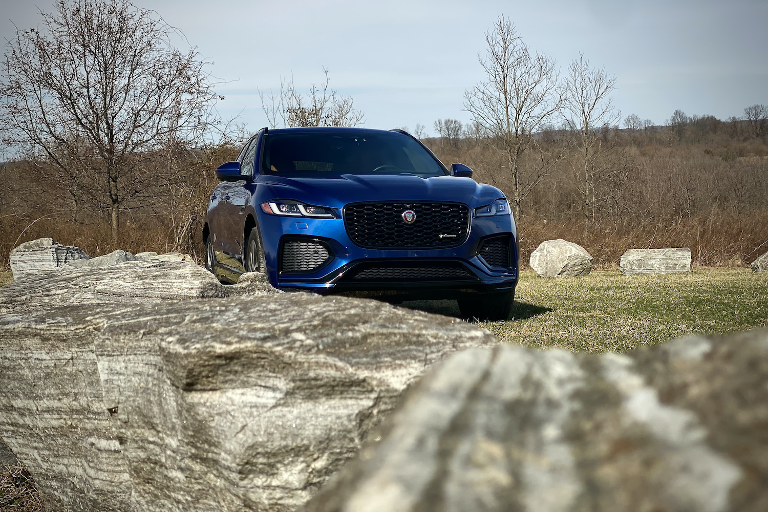 2022 Jaguar F-Pace R Dynamic S front end view with rocks in the forefront.