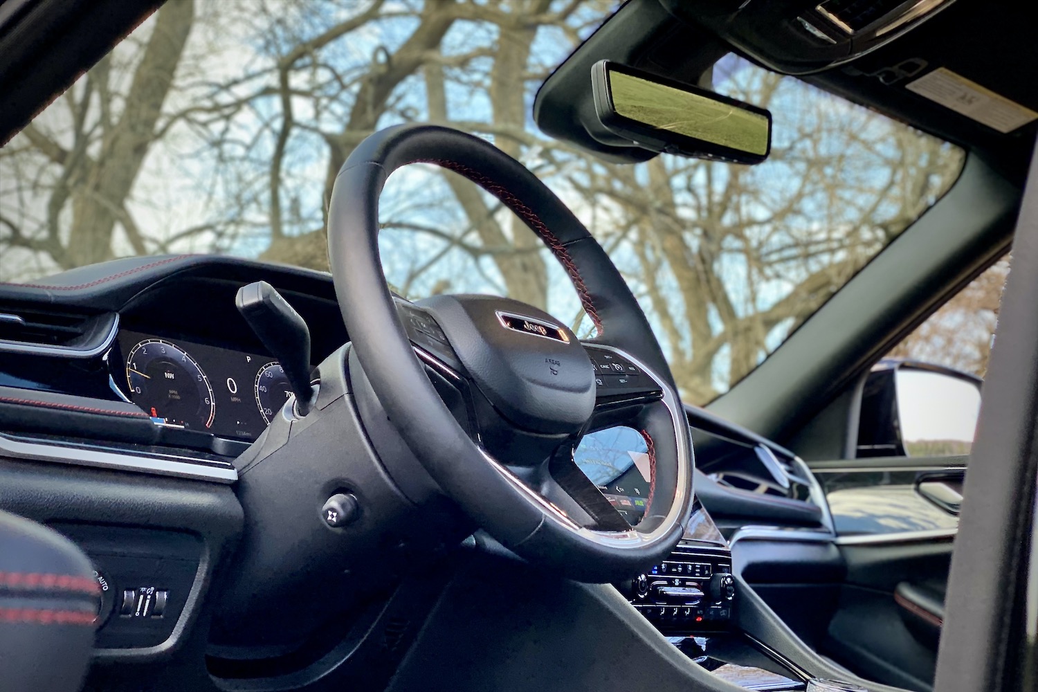 Close up of 2022 Jeep Grand Cherokee Trailhawk steering wheel from below.