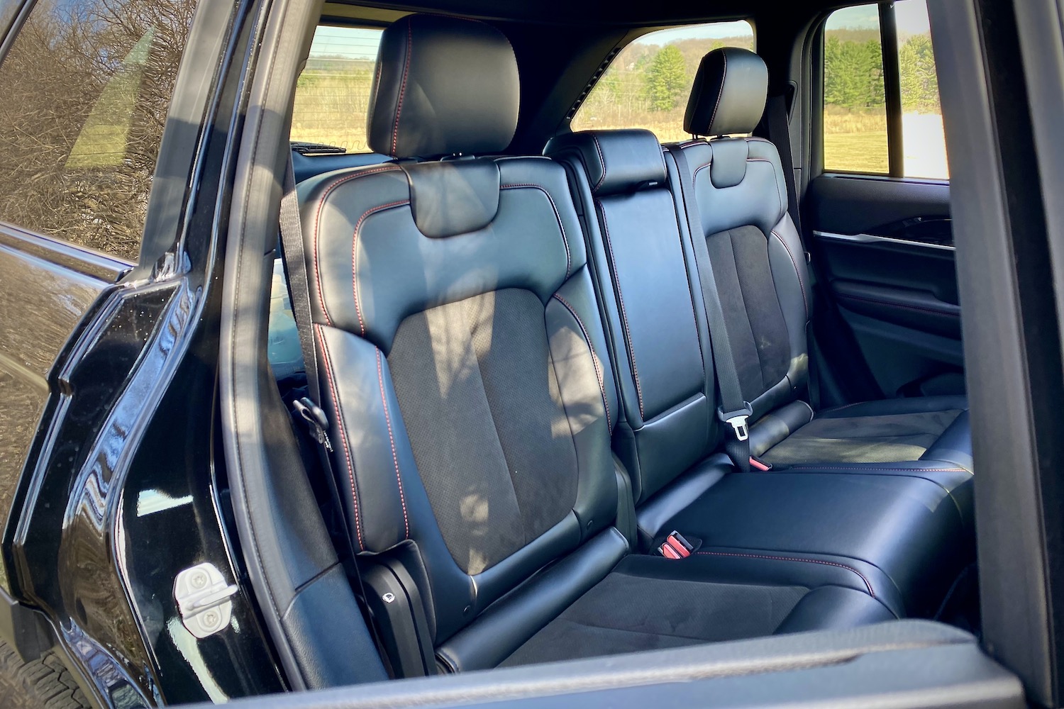 Rear seats in 2022 Jeep Grand Cherokee Trailhawk from passenger's side outside the SUV.