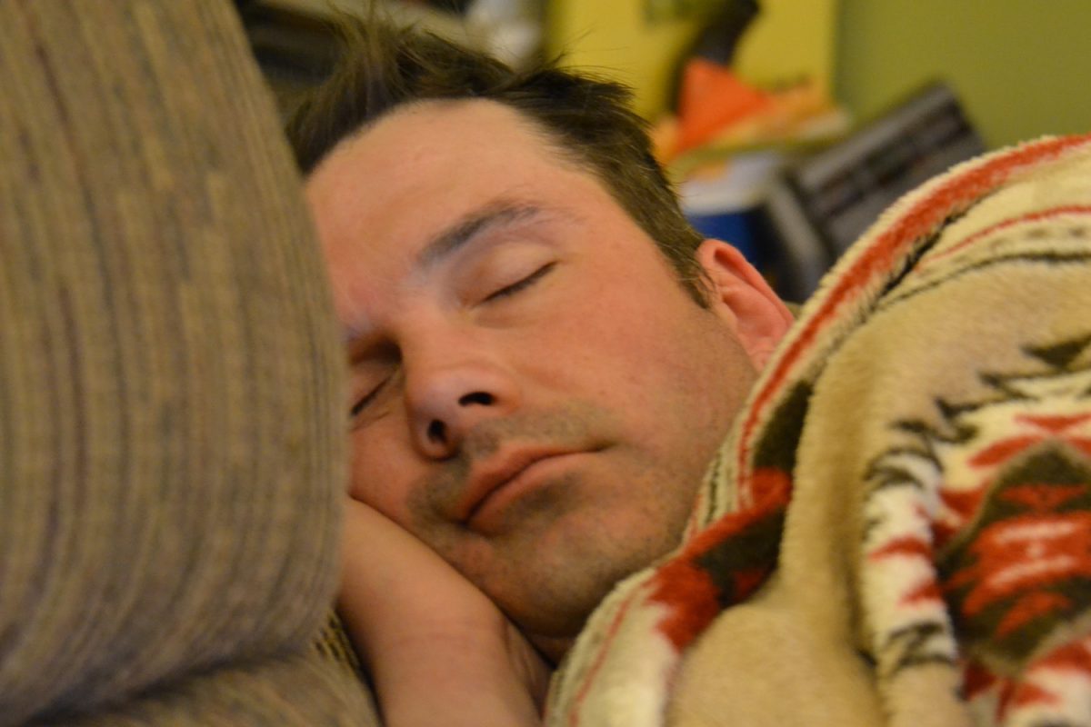 A man sleeps in his bed