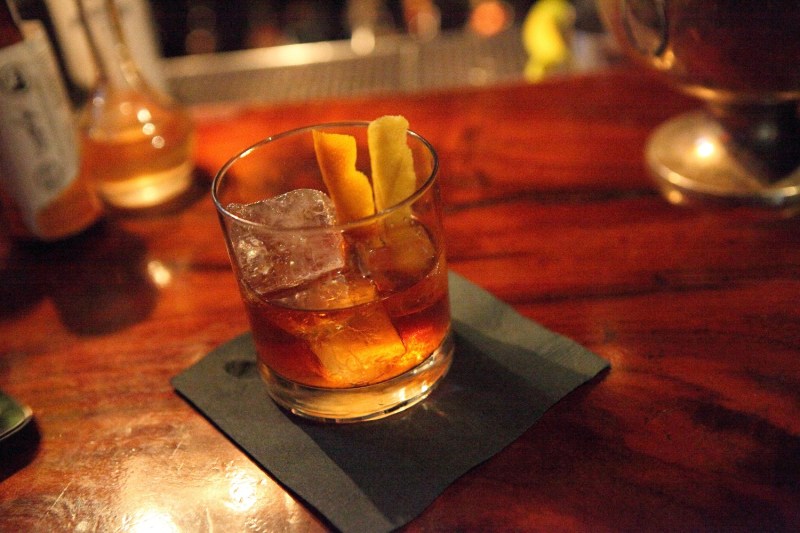 An Old Fashioned whiskey cocktail at a bar.