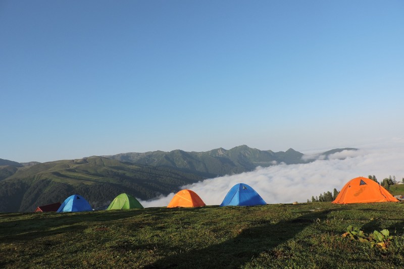 Tent campers at a campsite on a mountain ridge.