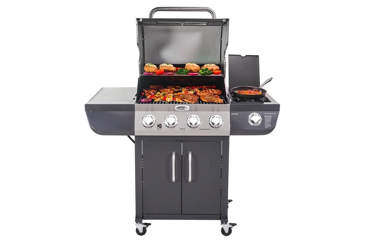 The Cuisinart 4-burner dual fuel gas grill sits open with various meats and vegetables on the grill.
