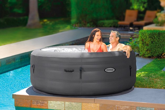 A couple relaxes in their Intex SimpleSpa portable inflatable hot tub.