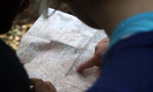 Two people look at a map and decide which way to turn.
