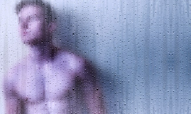 A man takes a shower.