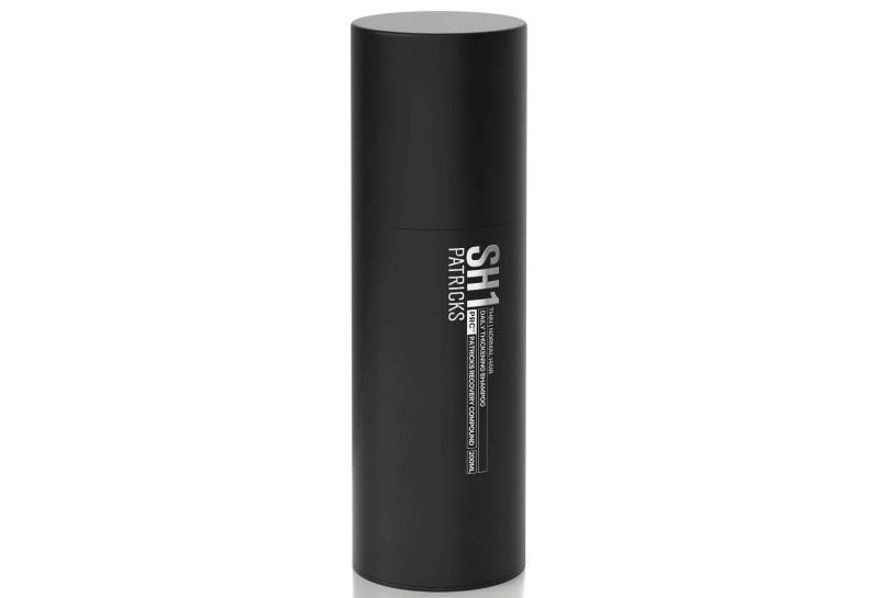 A bottle of Patricks Daily Thickening Shampoo.