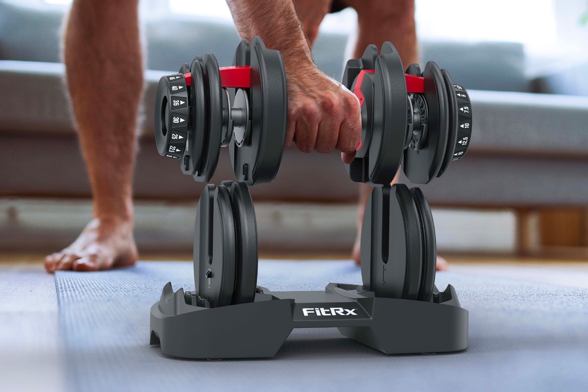 A man lifts the FitRx SmartBell adjustable dumbbell.
