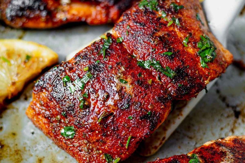 Cajun air fryer salmon with lemon on a platter