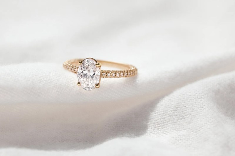 A gold engagement ring set with a Clean Origin lab-grown diamond.