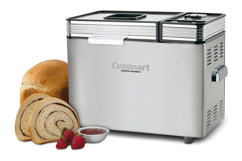 The Cusinart CBK-200 convection bread maker is sits next to a loaf of bread and strawberries.