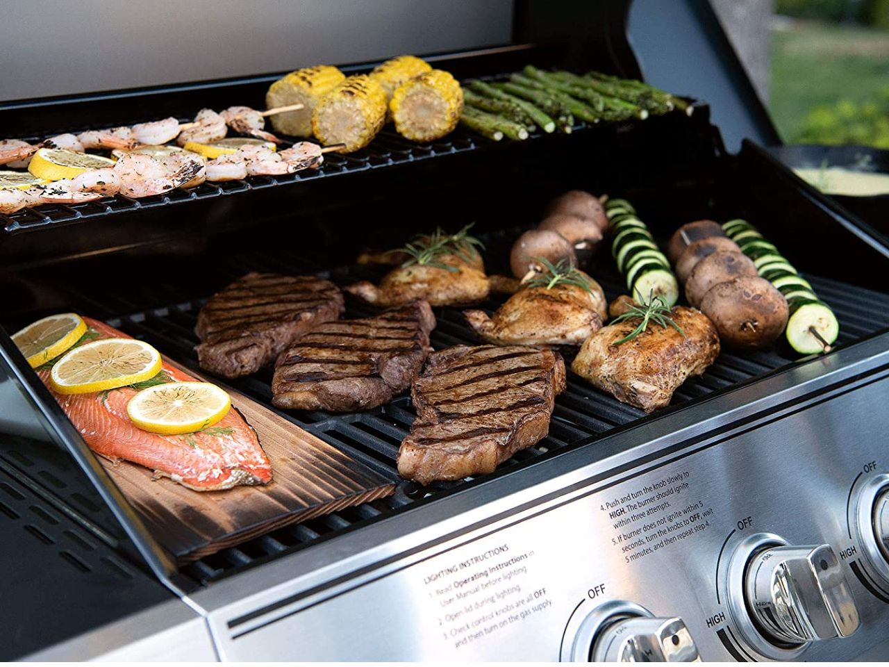 Expert Grill 5-burner gas grill cooking meats and side dishes.