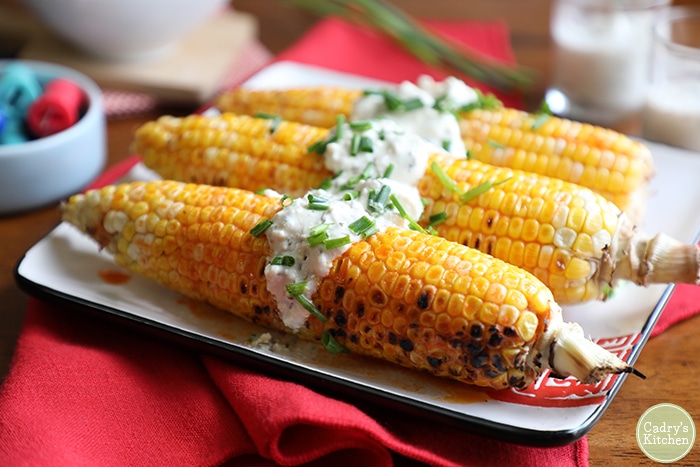 Corn on the cob with vegan blue cheese sauce.