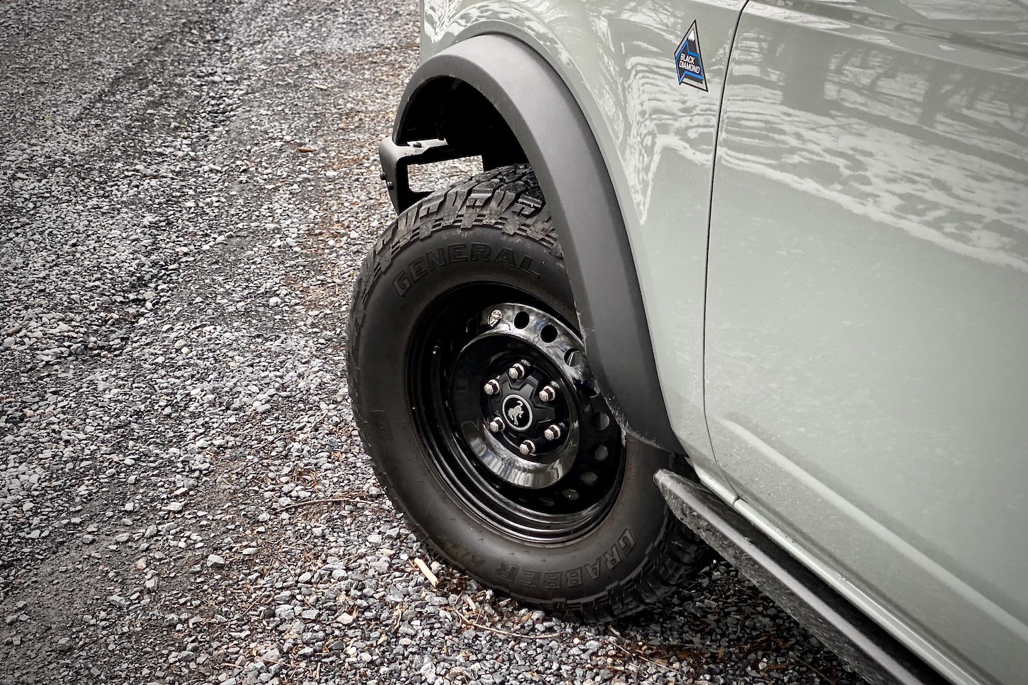 Close up of 2021 Ford Bronco front left tire from driver's side on a gravel trail.