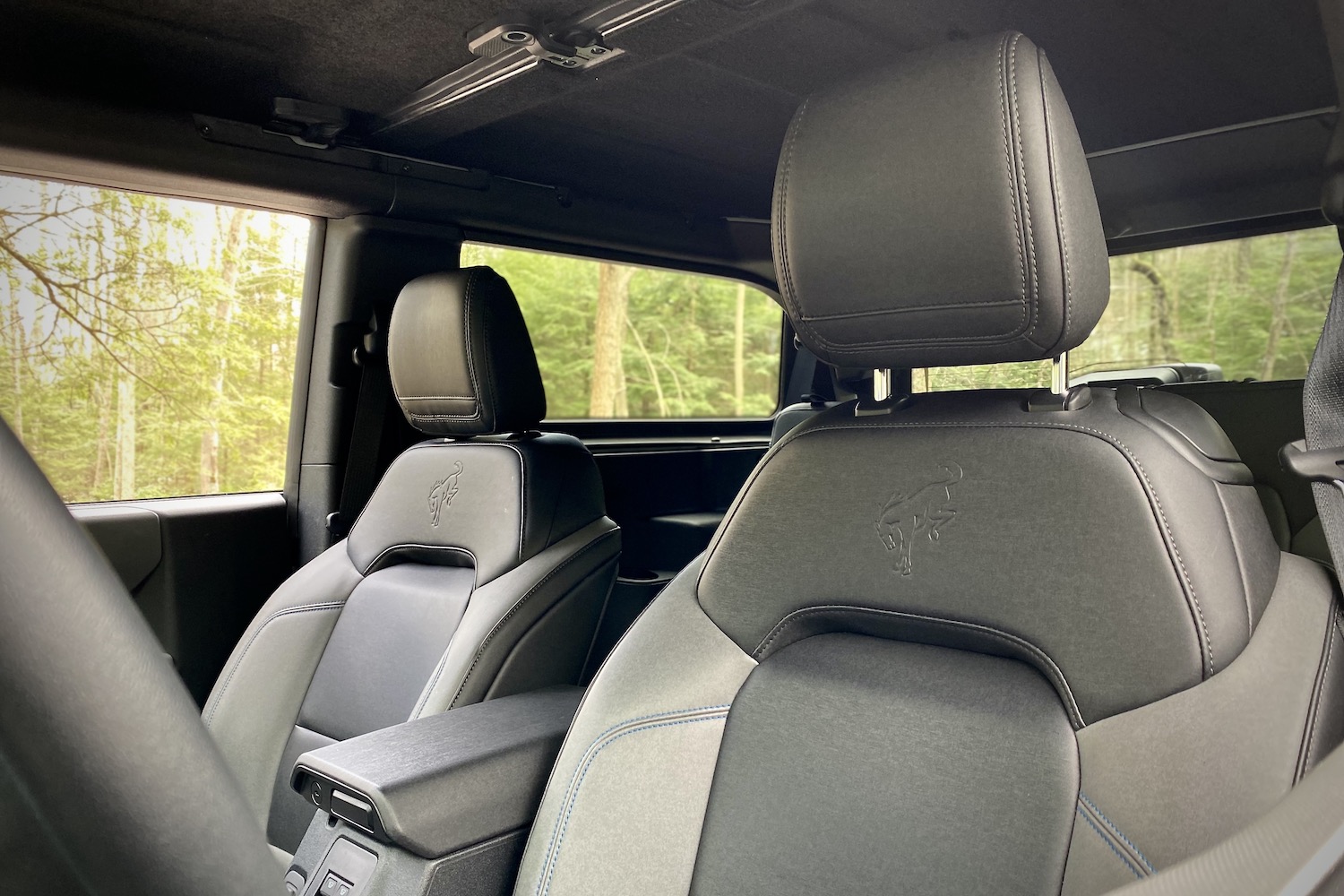 Front seat close up in 2021 Ford Bronco with marine grade vinyl upholstery with trees in the back.