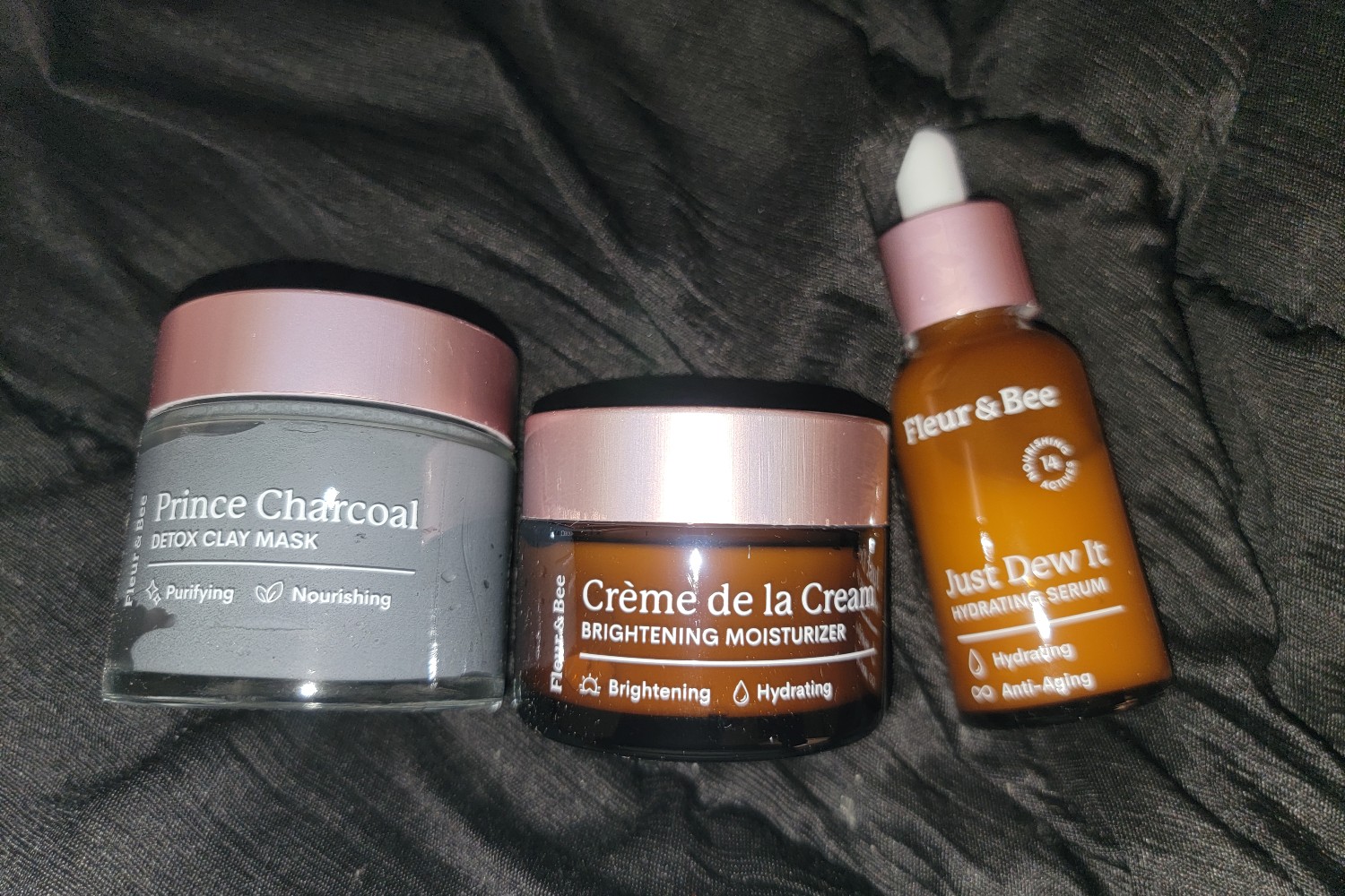 A collection of Fleur & Bee's clay mask, serum, and moisturizing cream.