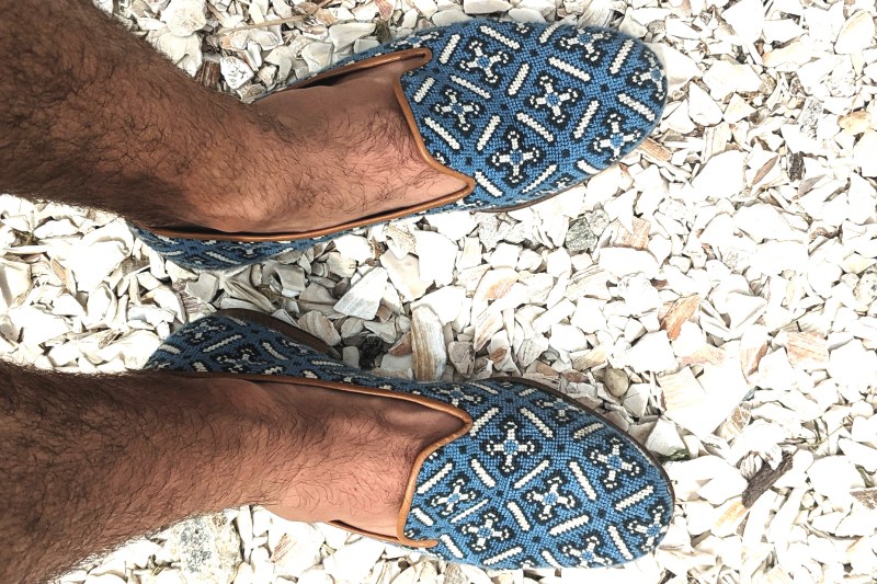 A pair of Stubbs and Wootton slippers on broken seashells