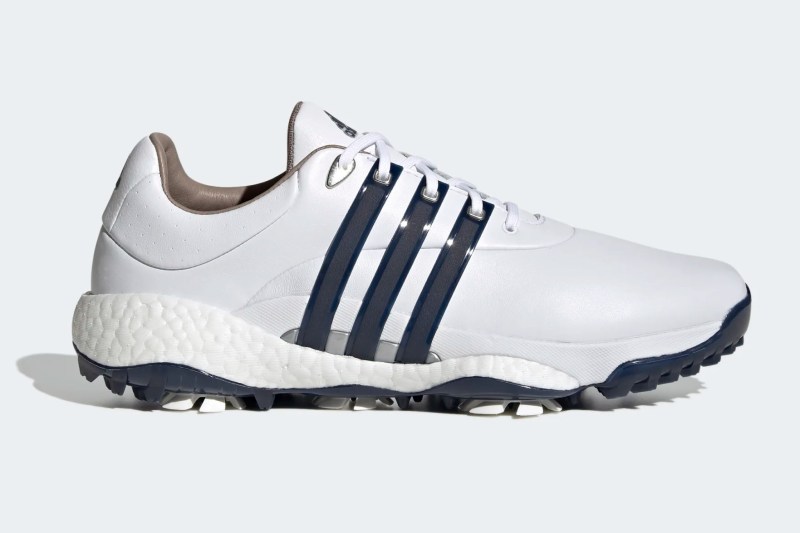 Adidas white golf shoe with blue stripes.